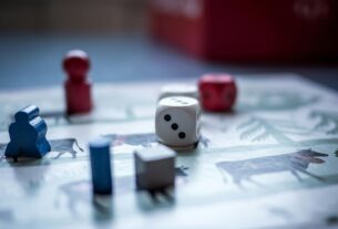 Dices and Wooden Pieces on Game Board